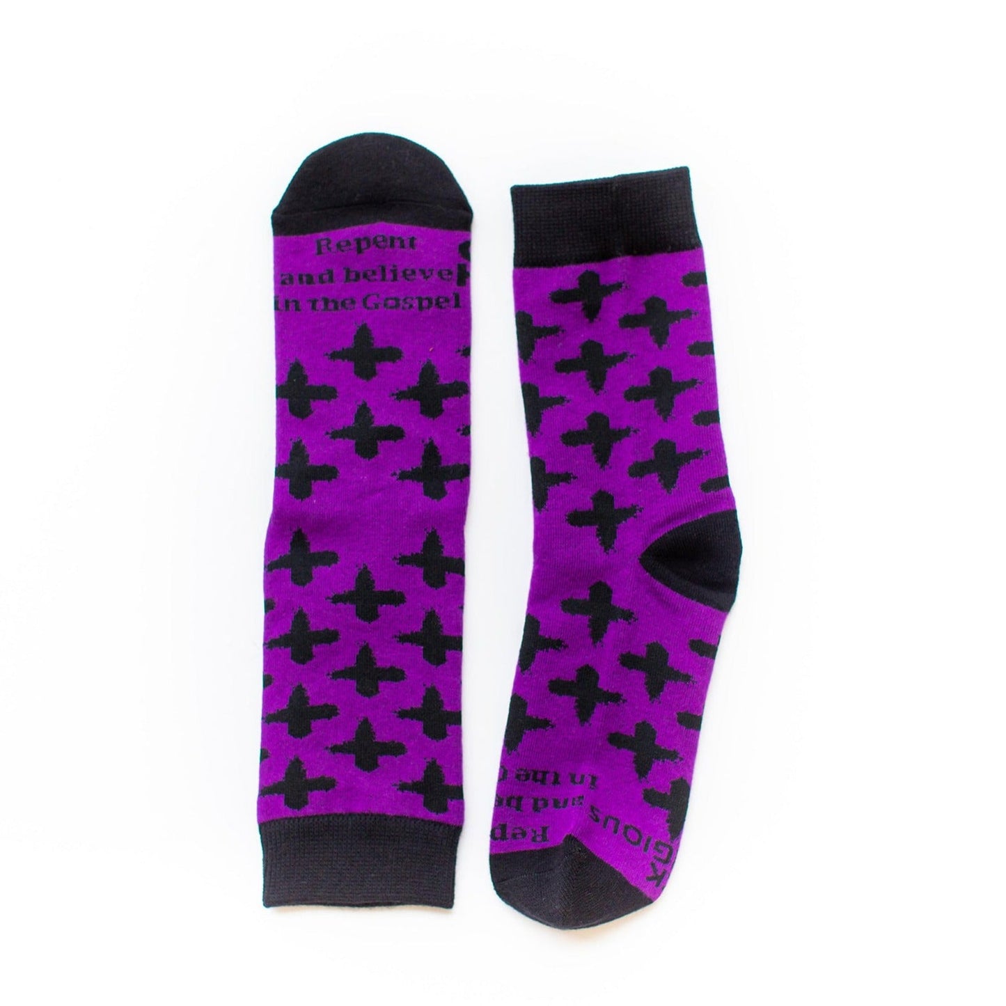 Purple socks with black ash crosses that say "repent and believe in the gospel' across the toe